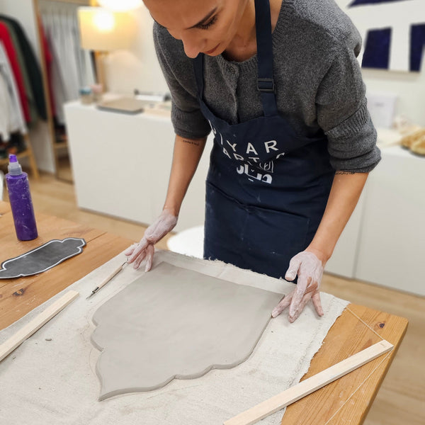 Person working on a wooden surface with tools and materials