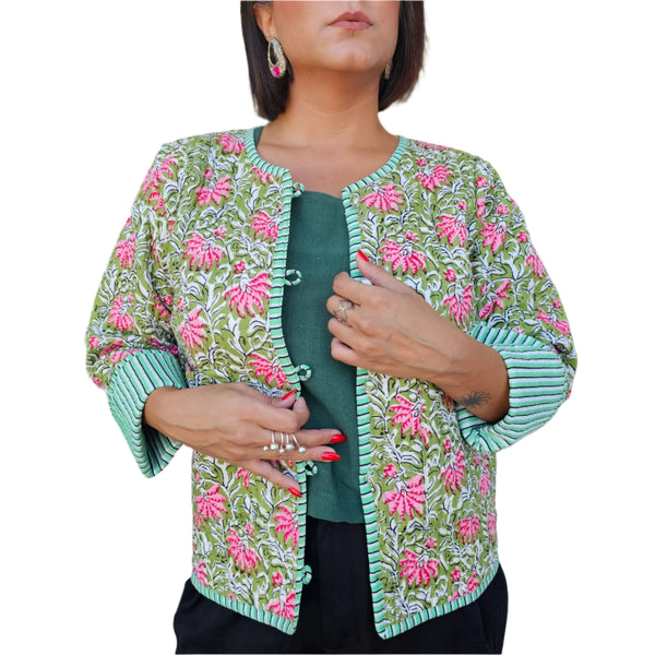 Woman wearing a floral embroidered jacket on a white background