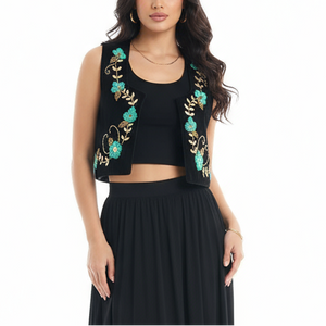 Woman wearing a black outfit with floral embroidery on a white background