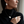 A woman in a black turtleneck sweater models a matching jewelry set featuring a silver-toned necklace, ring, and earring, each with a textured, organic white leaf or flower-like pendant.