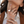 Close-up of a woman's hands wearing gold rings with a blurred background